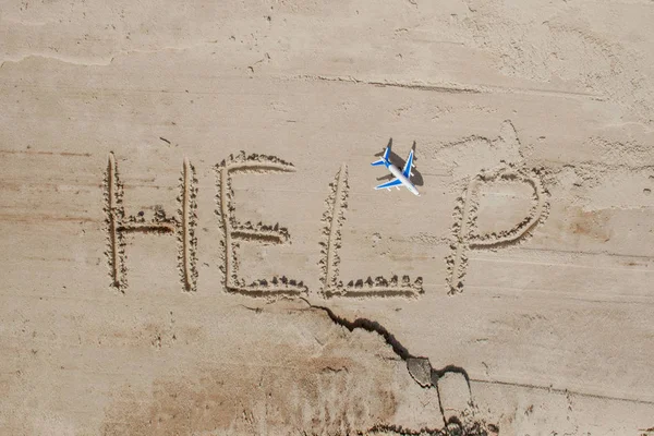 Help me the inscription and plane on the sand. Please help me. O