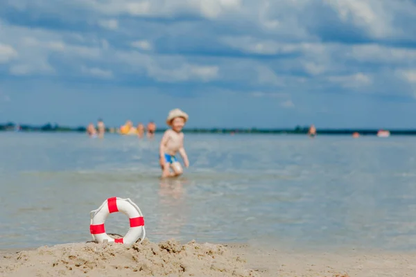 婴儿背景在海滩上的Lifebuoy的特写镜头。安全上 — 图库照片