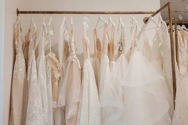 Assortment of dresses hanging on a hanger on the background stud