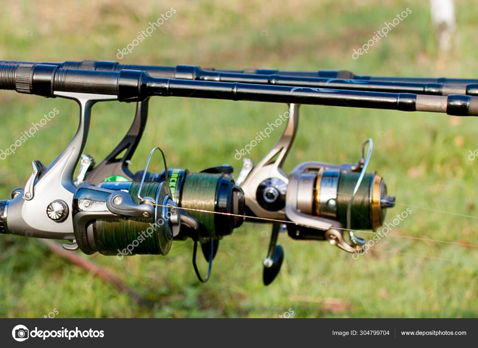 Closeup of a reel fishing rod on a prop and water background Stock