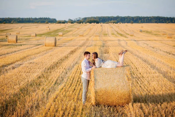 Happy young couple on straw, romantic people concept, beautiful landscape, summer season — Stock Photo, Image