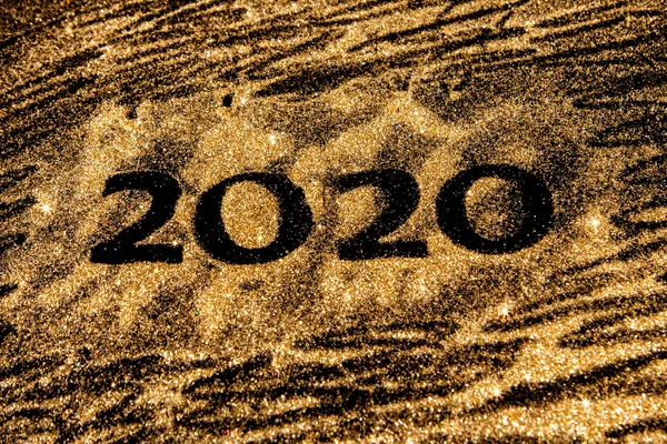 Happy New Year 2020. Creative Collage of numbers two and zero made up the year 2020. Beautiful sparkling Golden number 2020 on black background for design. — Stock Photo, Image