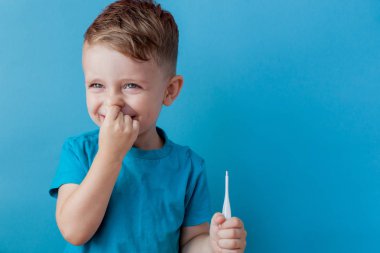 Bir termomether ile hasta küçük çocuk, onun yüksekliği ölçme