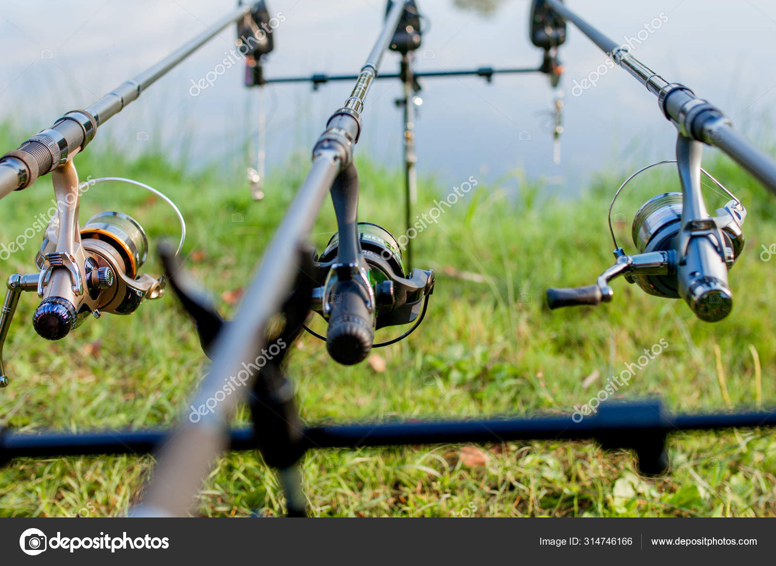 Closeup of a reel fishing rod on a prop and water background