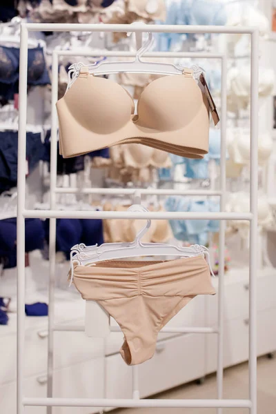 Premium Photo  A row of classic white bras on a hanger in a lingerie store  modern and fashionable interior of lingerie store