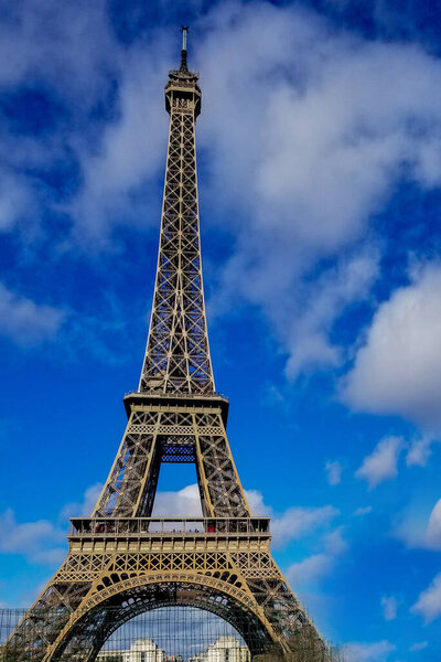 Beautiful photo of the Eiffel tower in Paris with gorgeous colors and wide angle central perspective.