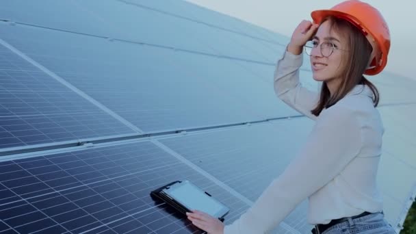 督察工程师妇女持有在太阳能电池板发电厂 光伏电池公园 绿色能源概念工作的数码平板电脑 — 图库视频影像