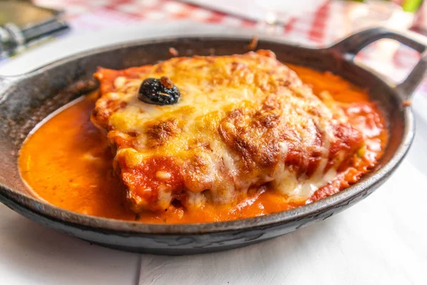 Traditional Italian lasagna with a lot of sauce in a pan — Stock Photo, Image