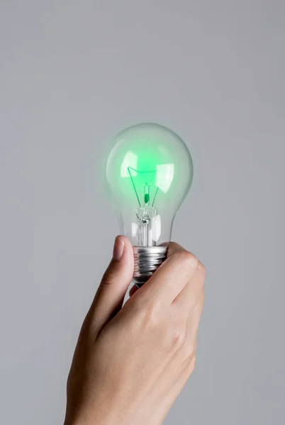 Realistic photo of Light bulb turn on in woman hand.