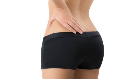 mükemmel sağlıklı vücut şekli poz ve onu geri ağrı alanında masaj, beyaz arka plan üzerinde izole kadın.