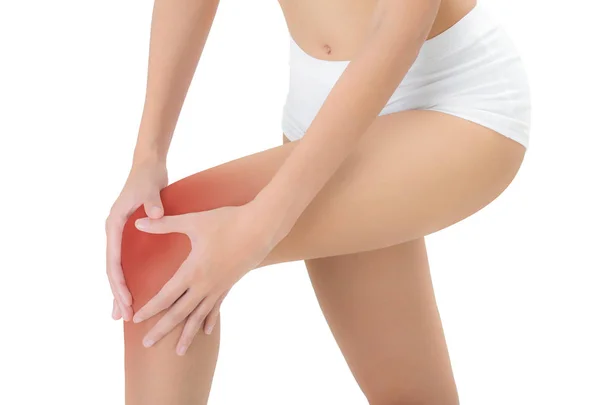 妇女抱着她美丽健康的长腿与按摩膝在疼痛区域与红色突出显示 孤立的白色背景 — 图库照片