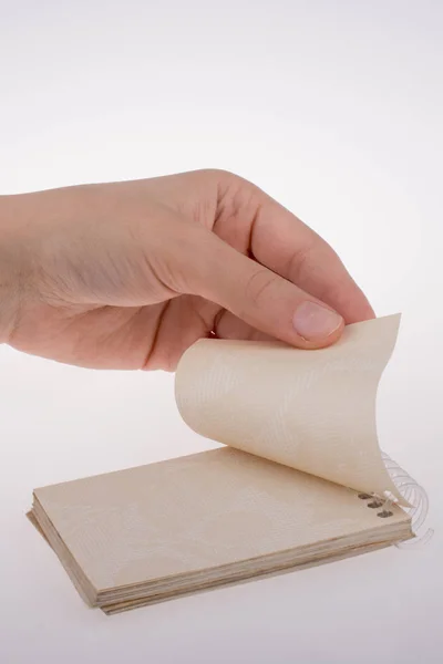 Mano Sosteniendo Cuaderno Espiral Sobre Fondo Blanco — Foto de Stock