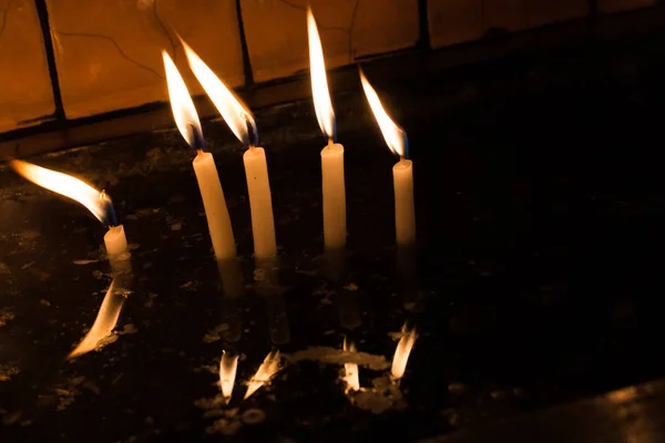 Burning candles with candle light in the dark