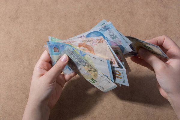 Hand holding American dollar  banknotes isolated on wooden background