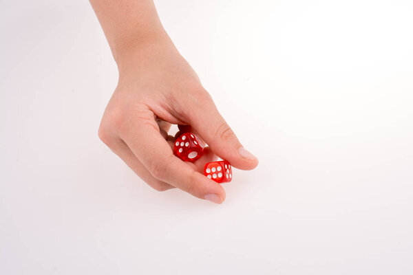 Hand holding red dice on a white background