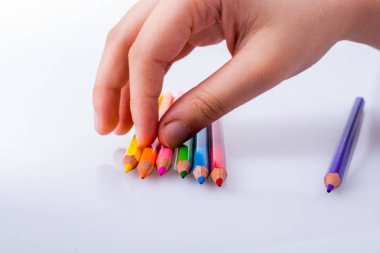 Beyaz arkaplana yerleştirilmiş el ele tutuşan kalemler