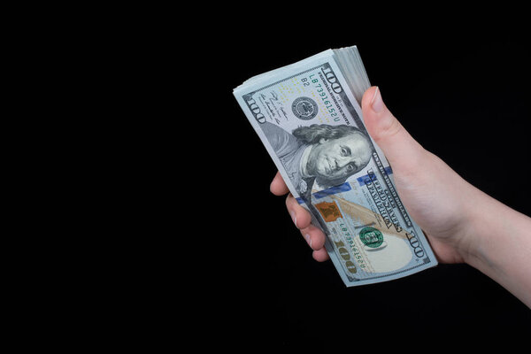 Hand holding American dollar  banknotes isolated on white background