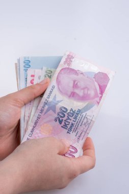 Turksh Lirası banknotlar beyaz arka plan üzerinde tutan el