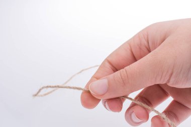 Keten iplik beyaz bir arka plan üzerinde tutan el