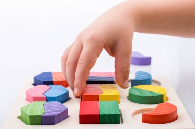 Elinde mantık bulmacasının renkli ahşap parçaları