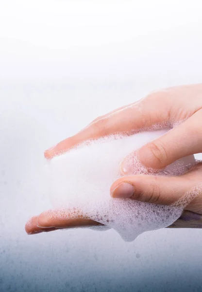 Hand washing and soap foam on a foamy background