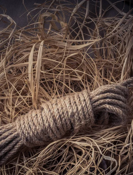 Bundle of linen rope  in a straw background