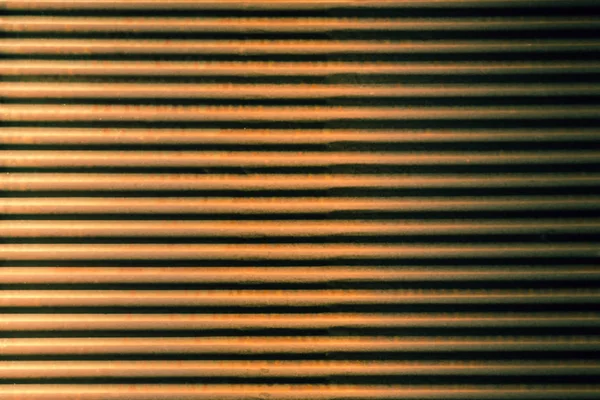 Straight lines on a shop front shutter as a metal background