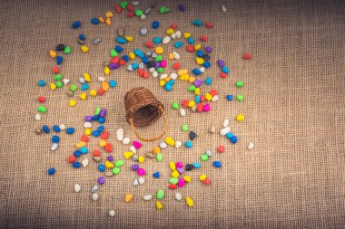 Sepet ve dökülen çakıl taşları tuval arka planda