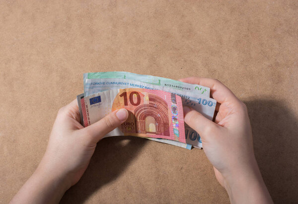 Hand holding American dollar  banknotes isolated on wooden background