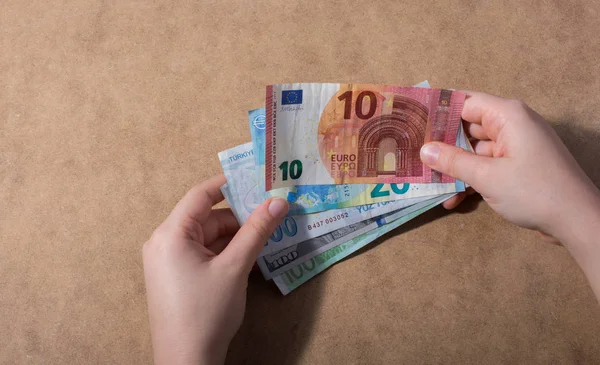 Hand holding American dollar  banknotes isolated on wooden background