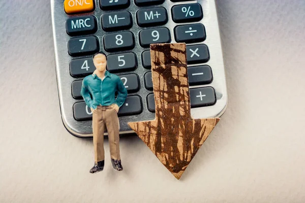 Mean figurine and arrow on Calculator device with a keyboard