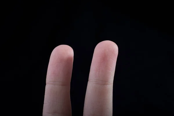 Two Fingers Child Hand Partly Seen Black Background — Stock Photo, Image