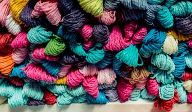 Bir pazar yerinde bir demet renkli ip görünüyor