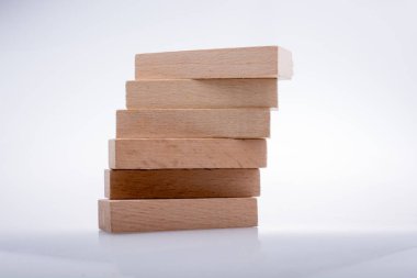 Wooden Domino Blocks in a line on a white background clipart