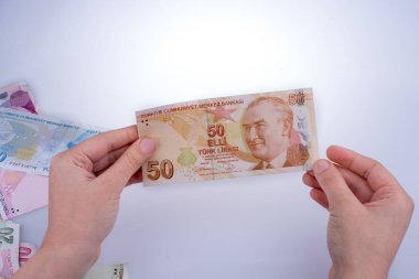 Turksh Lirası banknot beyaz arka plan üzerinde tutan el