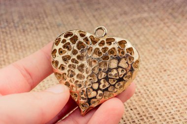 Kalp şeklinde altın renginde metal bir nesne