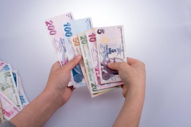 Turksh Lirası banknotlar beyaz arka plan üzerinde tutan el