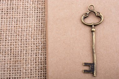 Retro altın renk anahtarı keten bir tuval üzerinde görüş tarz