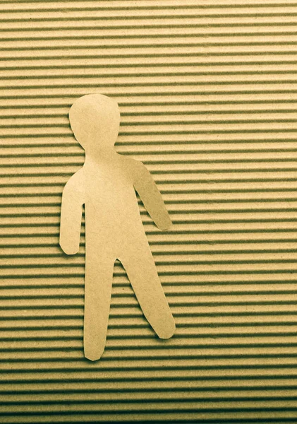 Man shape cut out of paper in hand in the view