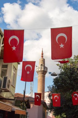 Bir minare bir iple bir direğe Türk ulusal bayrak dayan