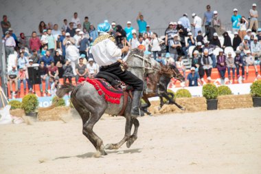 Atlılar at sırtında etnik kıyafetleriyle geziyorlar.