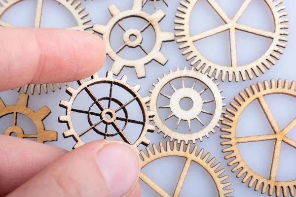 Gear wheel in hand on white background as concept of engineering — Stock Photo, Image