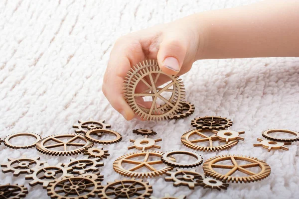 Gear wheel in hand on white background as concept of engineering