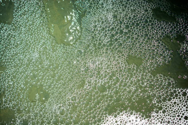 Water surface background with foam and bubbles — Stock Photo, Image