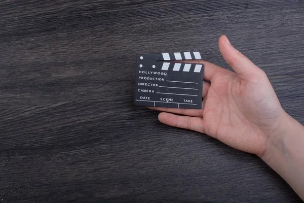 Hand holding a little movie  clapper in hand — Stock Photo, Image