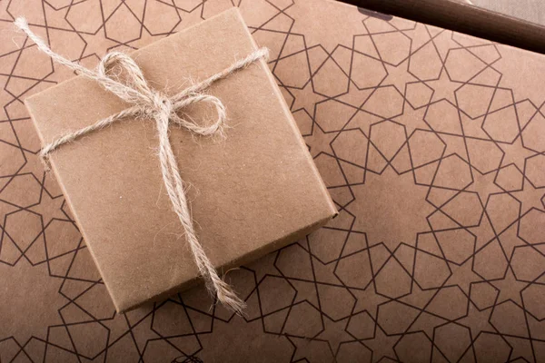 Gift box of brown color on a paper  background — Stock Photo, Image