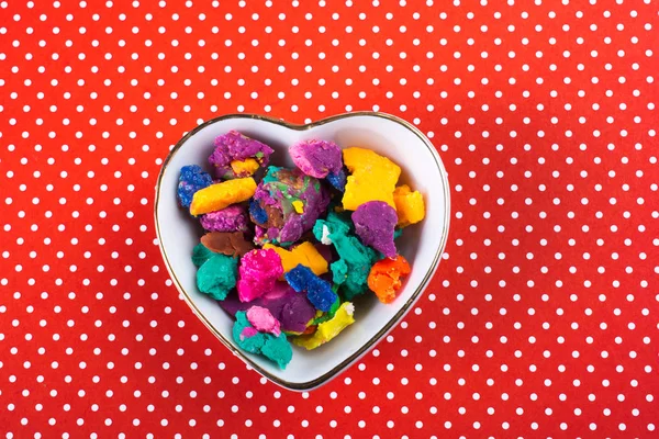 Dry colorful play dough in heart shaped bowl — Stock Photo, Image