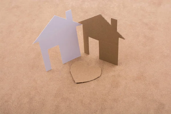 Heart shaped icon and paper houses — Stock Photo, Image