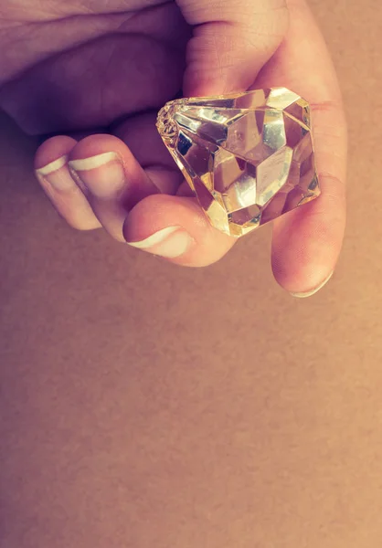 Fake diamond stone in hand