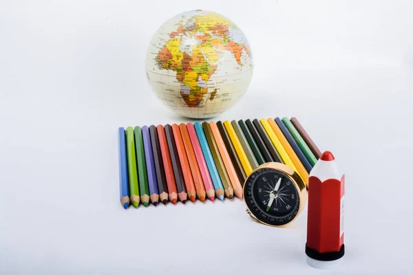 Colour pencil with compass, pen and a globe — Stock Photo, Image